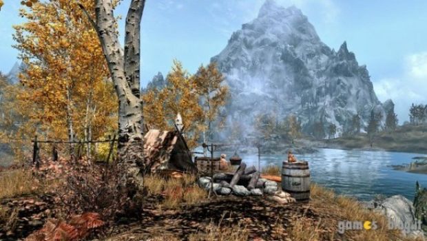 Elder Scrolls V: Skyrim - una guerriera e un paesaggio montano ritratti in immagini