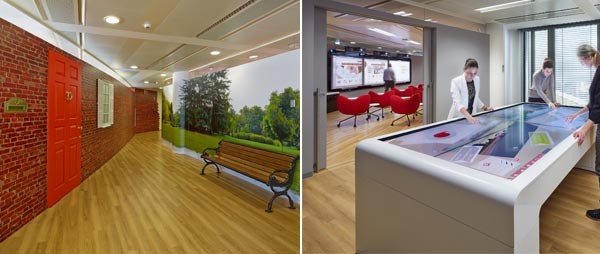 Vodafone ha costruito un village che fin dalla prima sala riproduce un ambiente familiare. Insieme a questo, però. anche molta tecnologia, come (a destra) la sala con il tavolo touch.